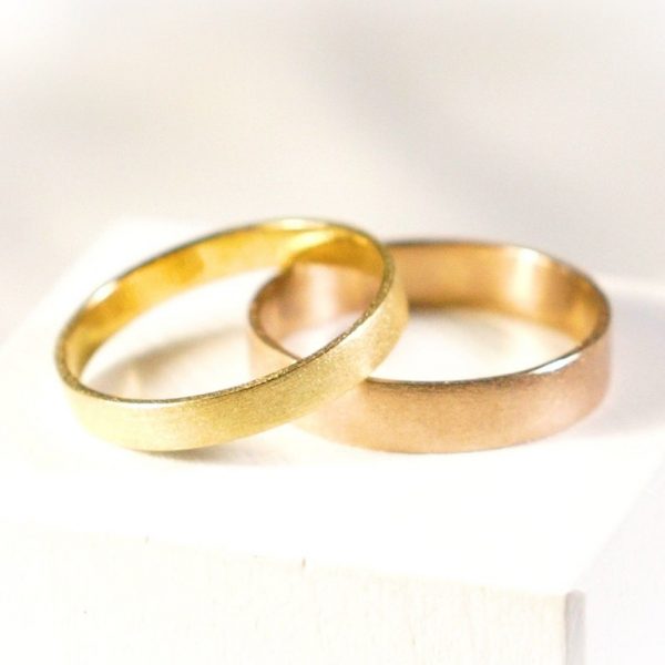 Wedding band rings set in certified Fairmined yellow and rose gold sand finishing