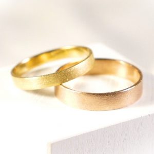 Wedding band rings set in certified Fairmined yellow and rose gold sand finishing
