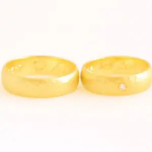 Half round wedding rings set in 14k, 18k or 22k Fairmined gold with a Fairtrade diamond